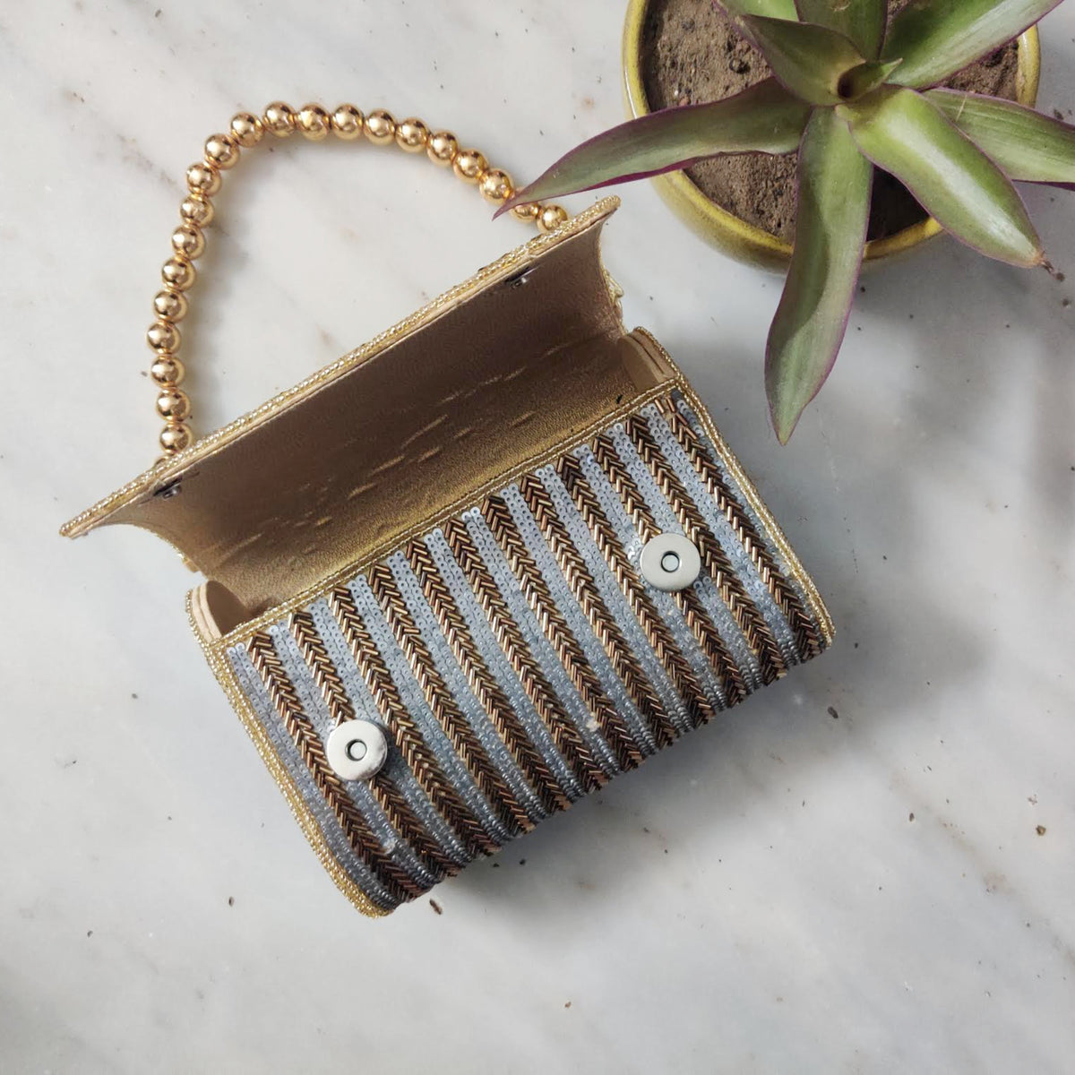 Antique gold flap over handembroidered clutch