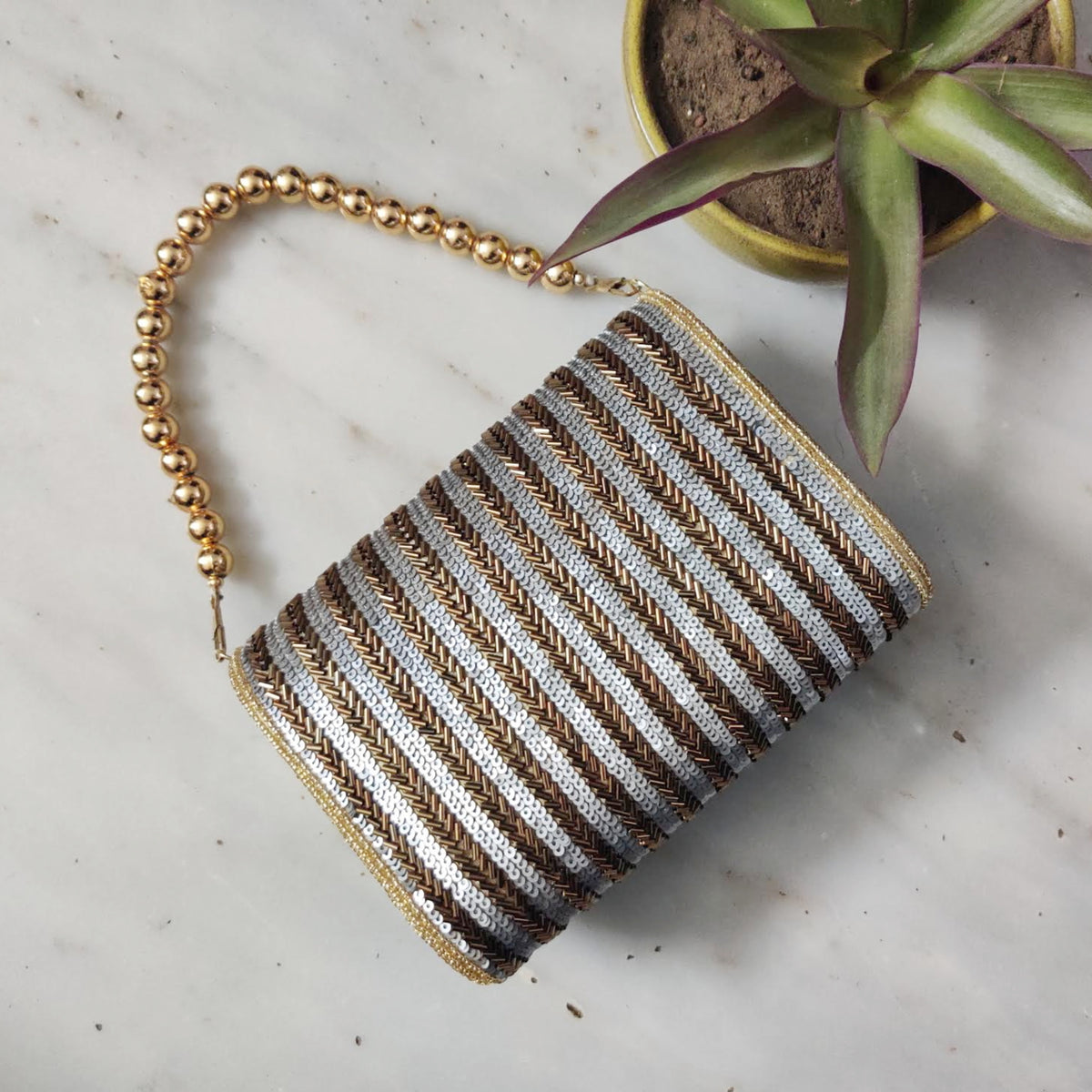 Antique gold flap over handembroidered clutch