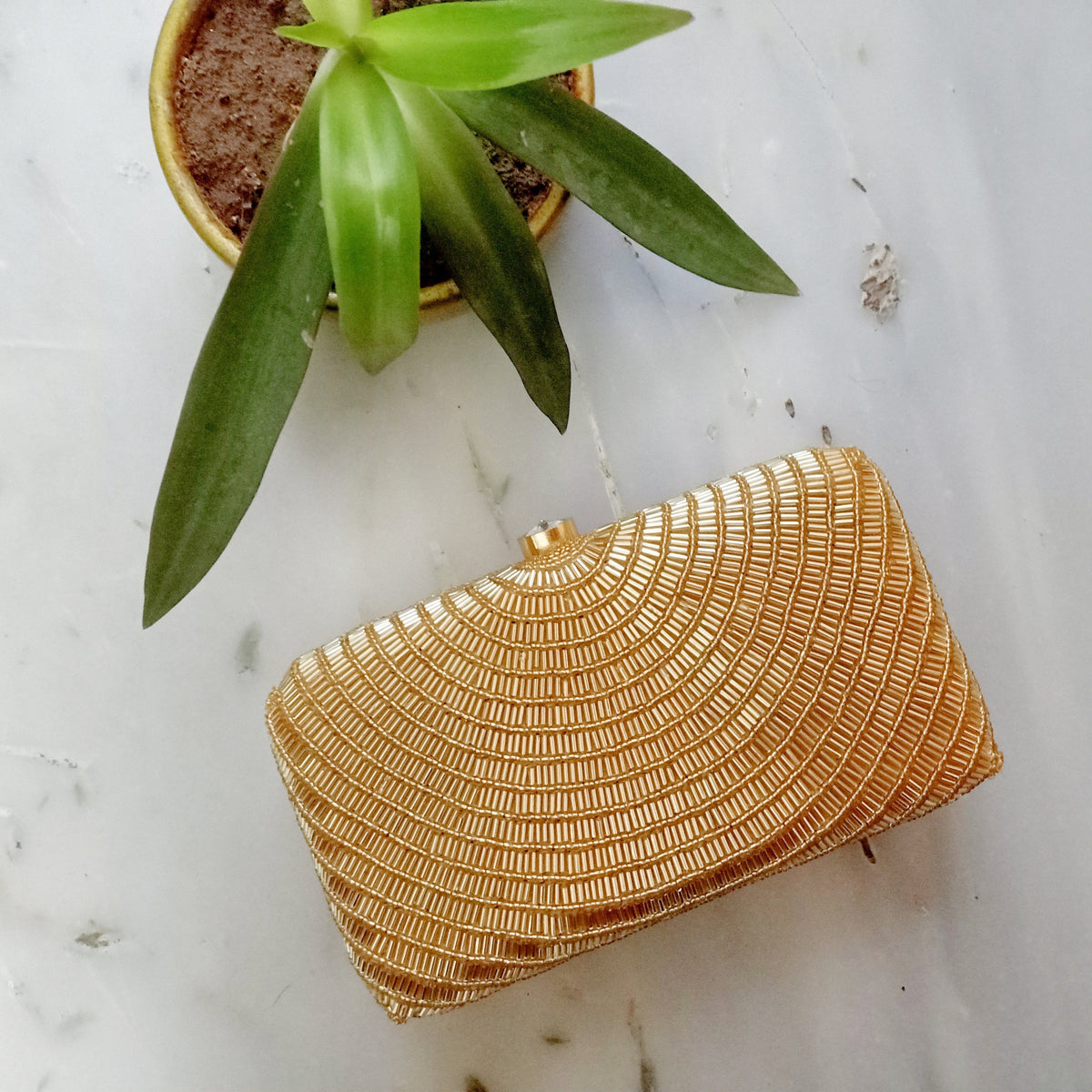 Gold cleopatra clutch