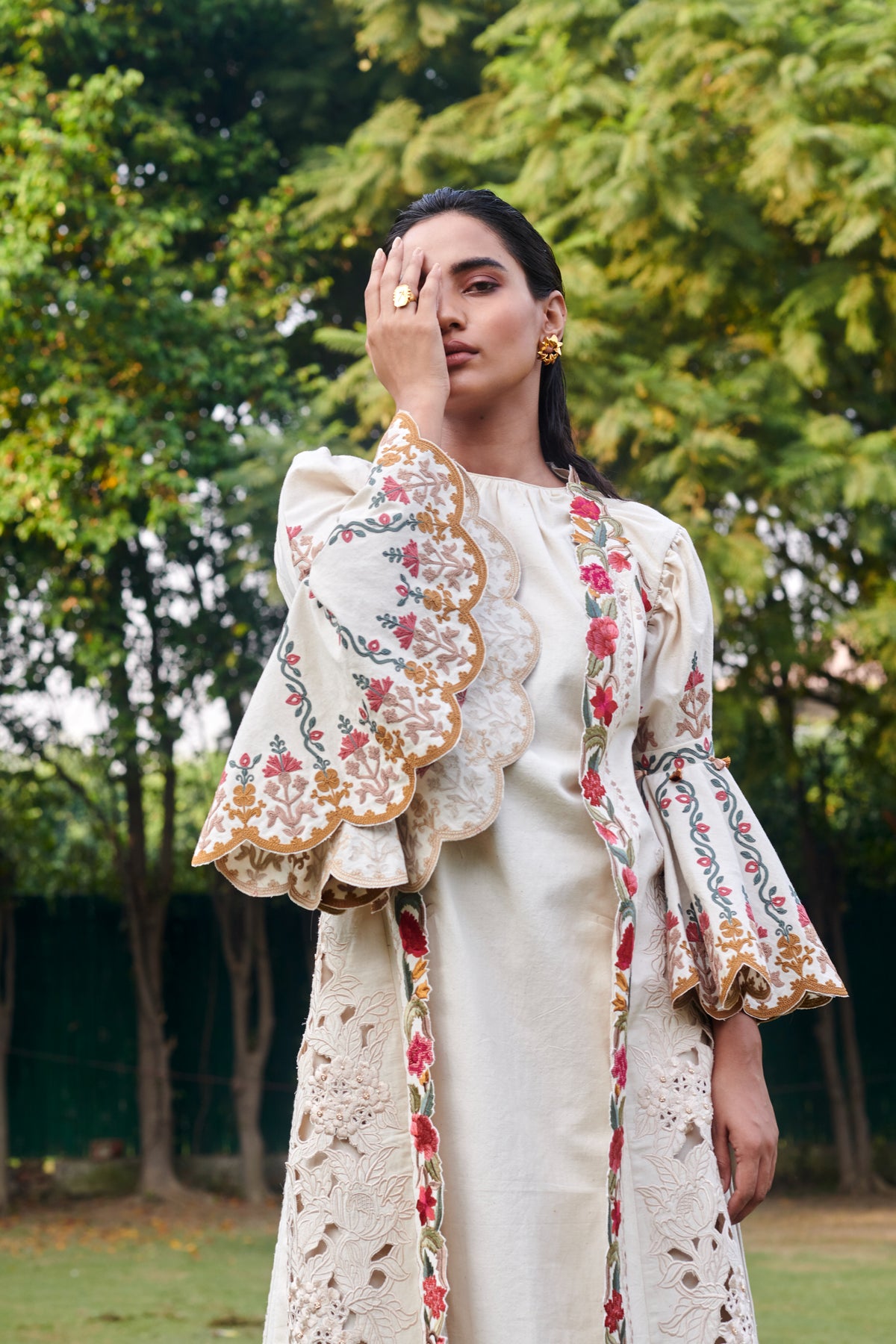 Ivory cutwork sleeveless jacket