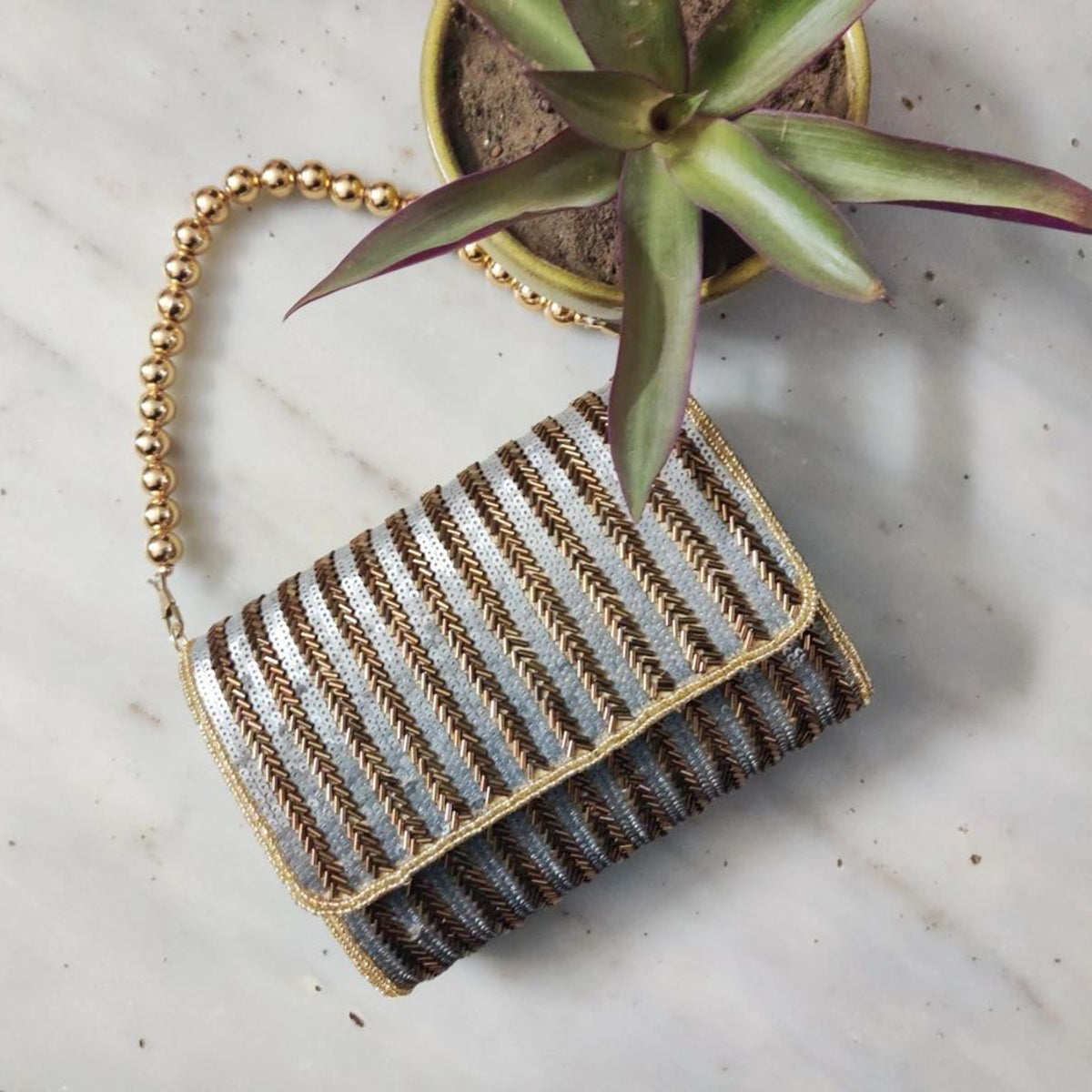 Antique gold flap over handembroidered clutch