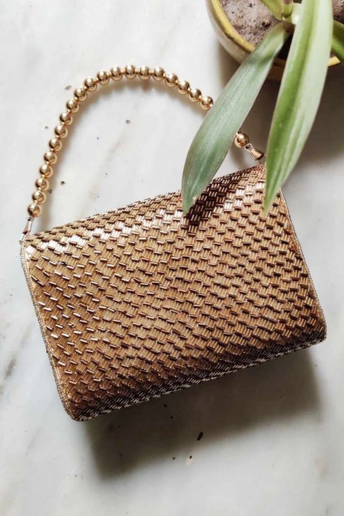Gold weave flapover clutch