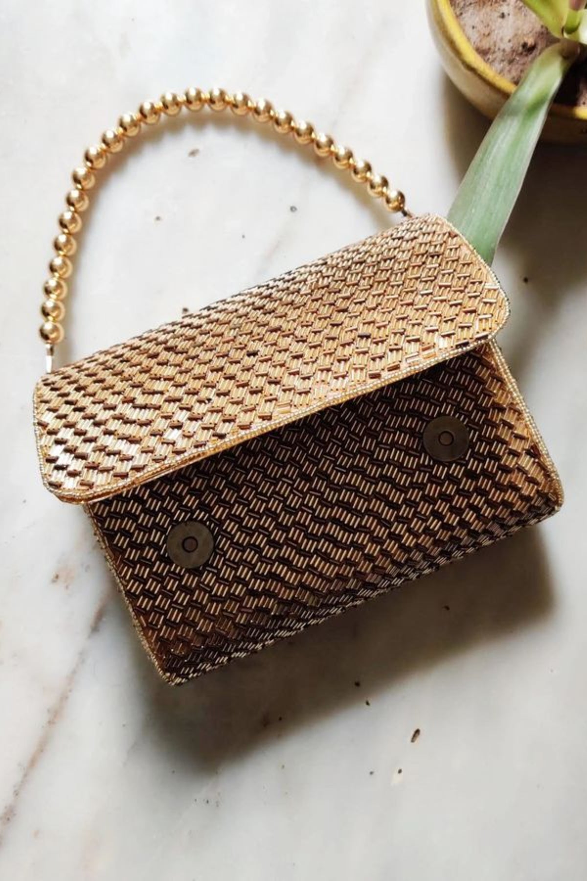 Gold weave flapover clutch